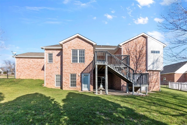 rear view of house featuring a patio, a deck, and a lawn