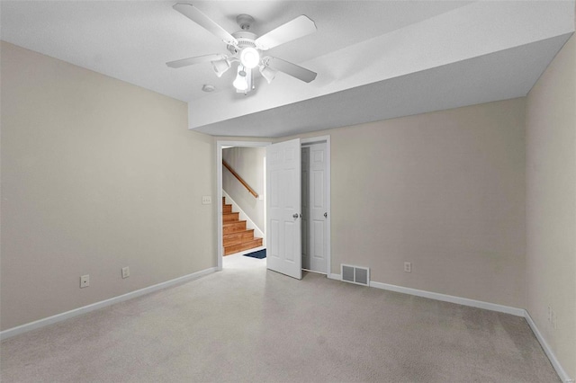 carpeted spare room with ceiling fan