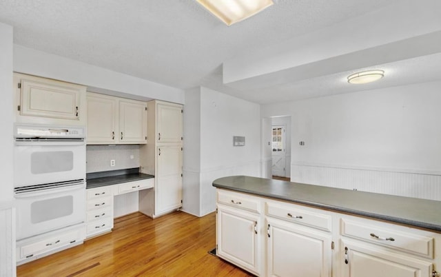 kitchen featuring light hardwood / wood-style floors and double oven