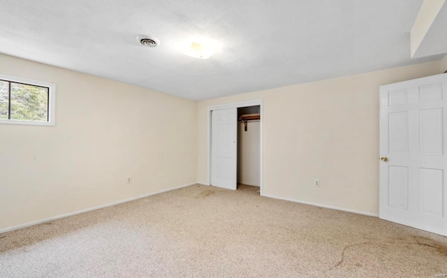 unfurnished bedroom with carpet and a closet