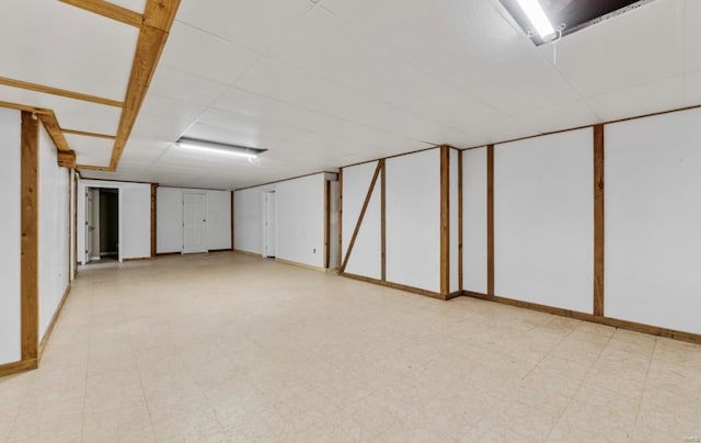 basement featuring a paneled ceiling