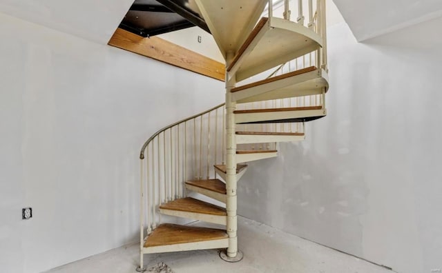 stairway featuring concrete floors