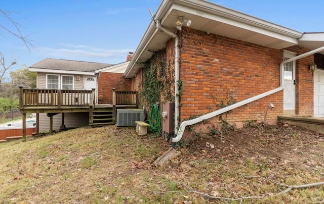 view of side of home featuring central AC and a deck