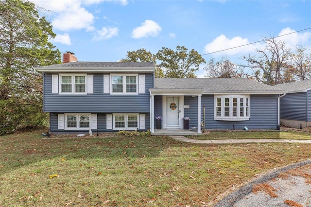 split level home with a front lawn