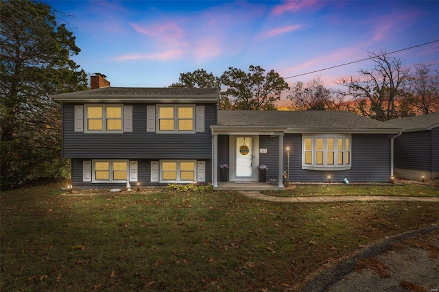 split level home with a lawn