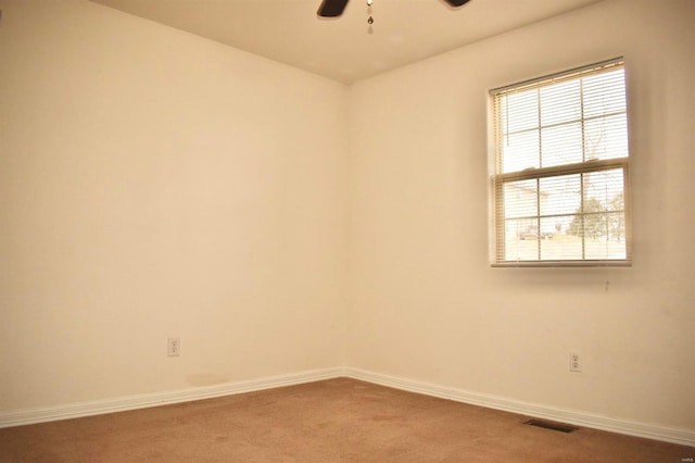 empty room featuring carpet floors and ceiling fan