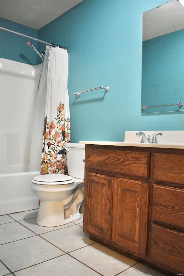 full bathroom with tile patterned floors, shower / bathtub combination with curtain, vanity, and toilet