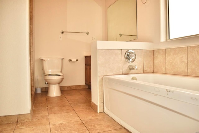 bathroom with tile patterned floors, a bathtub, and toilet