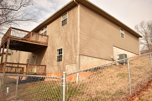 view of property exterior featuring a wooden deck and central AC