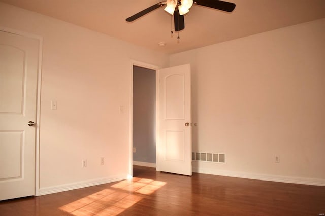 unfurnished bedroom featuring dark hardwood / wood-style flooring and ceiling fan