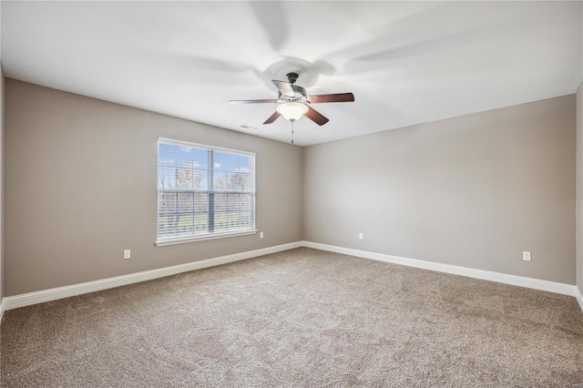 carpeted spare room with ceiling fan