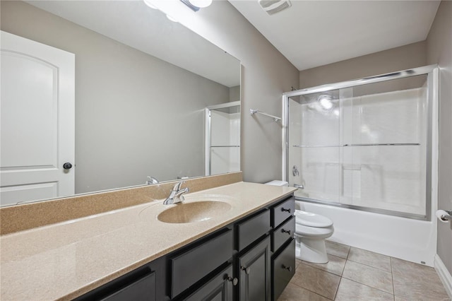 full bathroom featuring tile patterned floors, vanity, toilet, and shower / bath combination with glass door