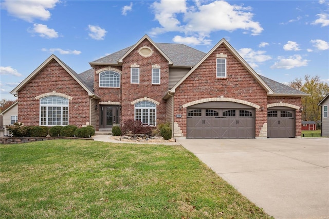 view of front of home with a front yard and a garage