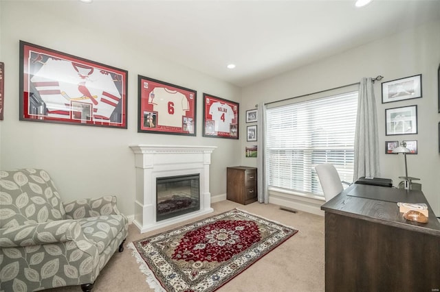 carpeted home office with recessed lighting, visible vents, baseboards, and a glass covered fireplace