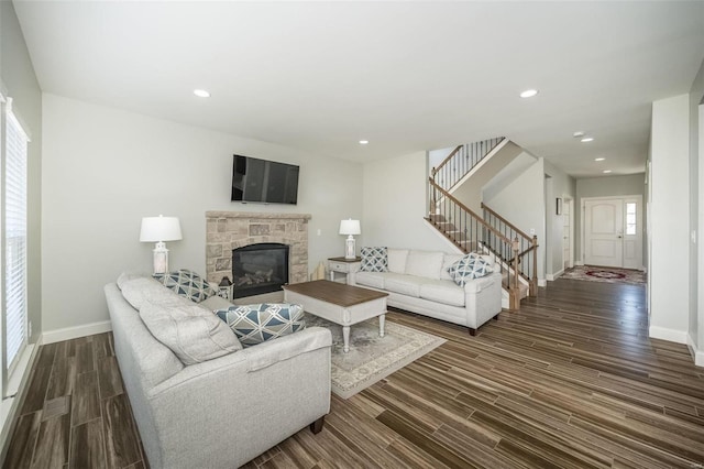 living area with stairs, baseboards, dark wood-type flooring, and recessed lighting