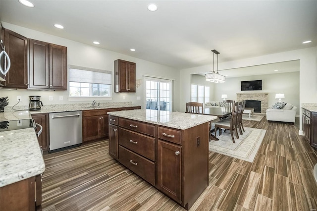 kitchen with plenty of natural light, a center island, a sink, and stainless steel dishwasher