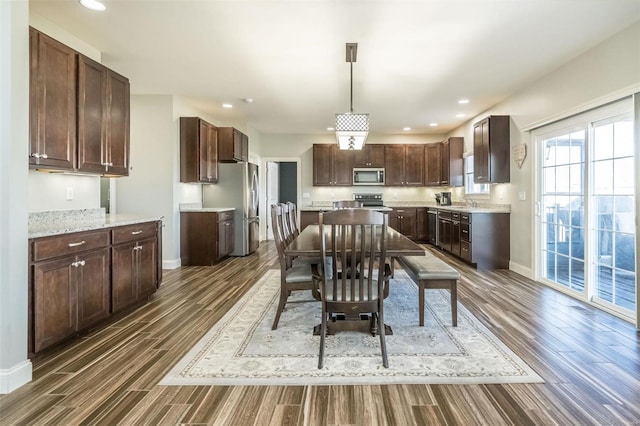 dining room with baseboards, dark wood-style flooring, and recessed lighting