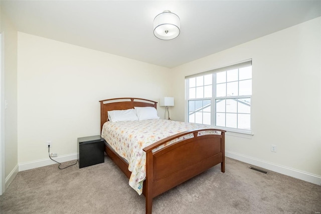 carpeted bedroom featuring visible vents and baseboards