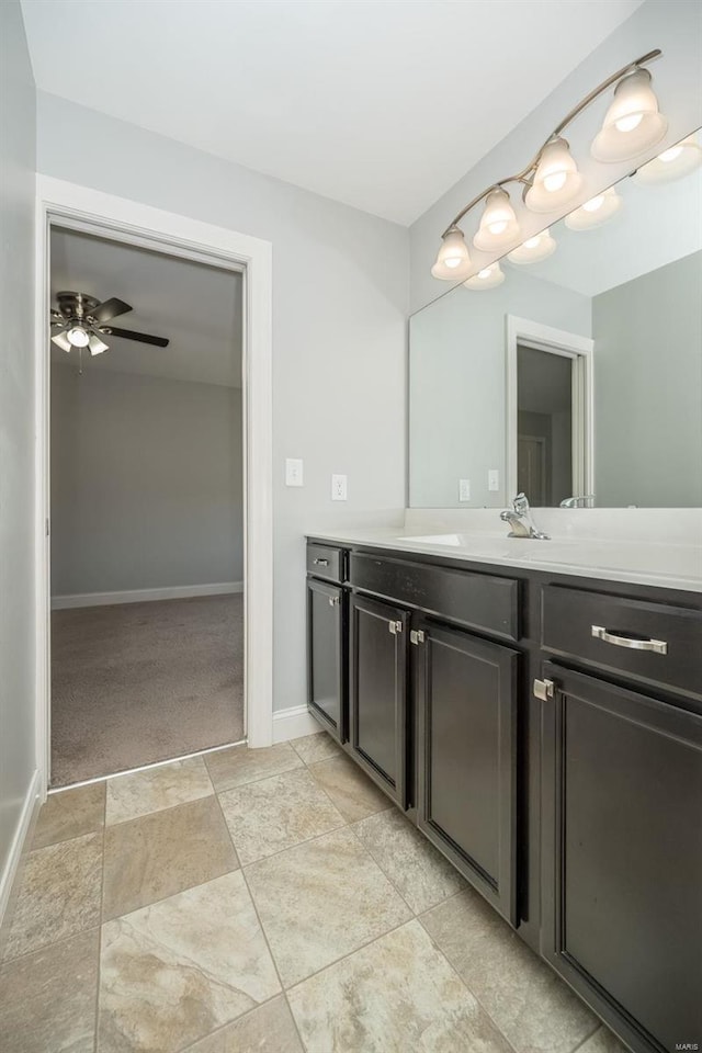 bathroom featuring a ceiling fan, vanity, and baseboards