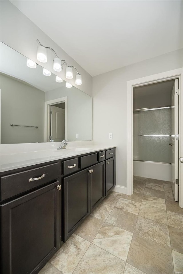 full bathroom featuring  shower combination, vanity, and baseboards