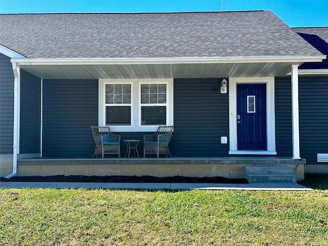 doorway to property featuring a lawn and a porch