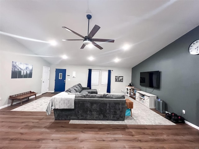 living room featuring ceiling fan, lofted ceiling, and hardwood / wood-style flooring