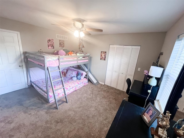 carpeted bedroom featuring ceiling fan and a closet