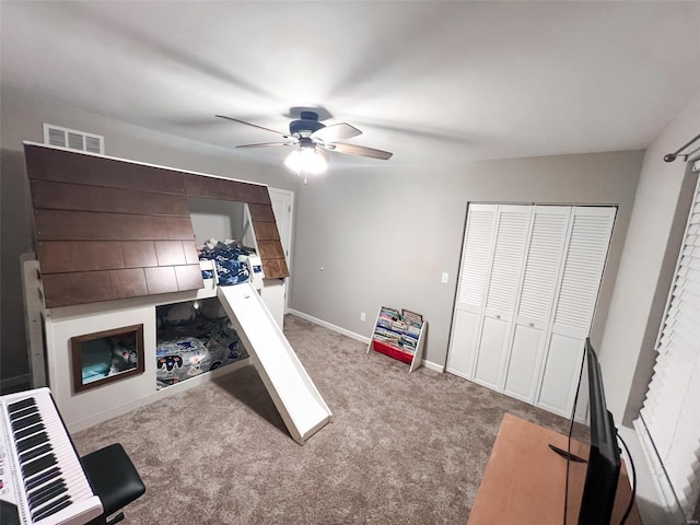 playroom with light carpet and ceiling fan