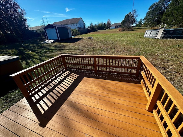 deck featuring a yard and a storage unit