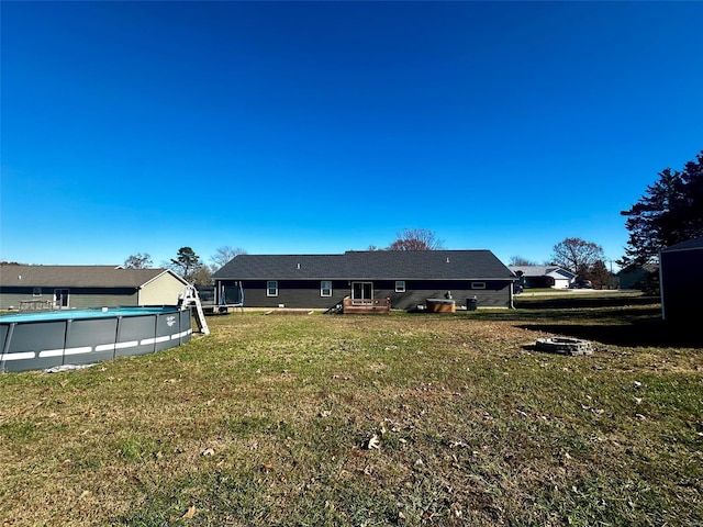 rear view of house featuring a yard