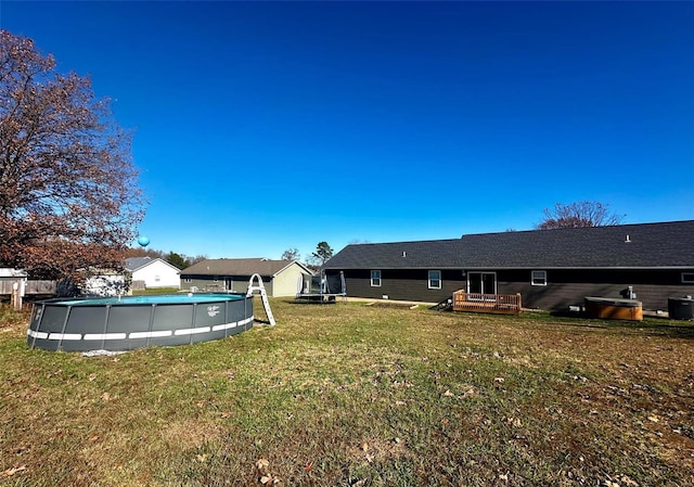 view of yard with a pool side deck