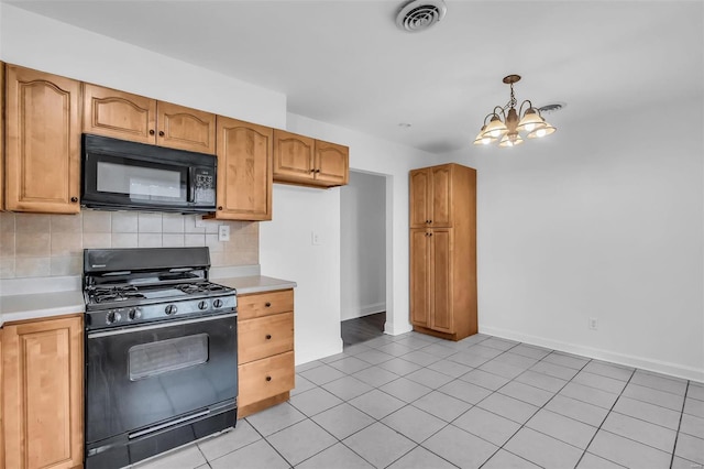 kitchen with backsplash, an inviting chandelier, black appliances, hanging light fixtures, and light tile patterned flooring