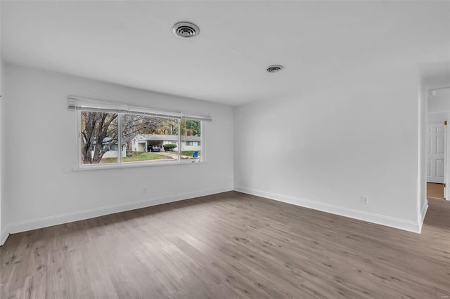 unfurnished room with hardwood / wood-style flooring