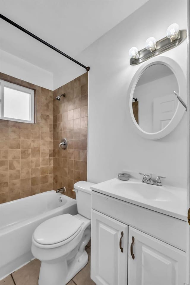 full bathroom with tile patterned floors, tiled shower / bath combo, toilet, and vanity