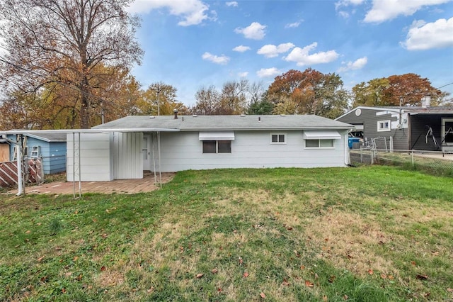 rear view of house featuring a lawn