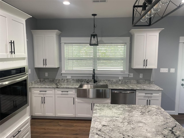 kitchen featuring white cabinetry, appliances with stainless steel finishes, dark wood-type flooring, and sink