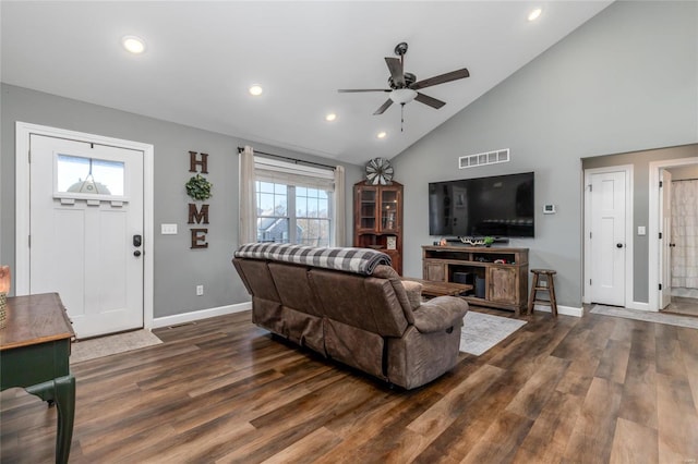 living room featuring plenty of natural light, dark wood-type flooring, and ceiling fan