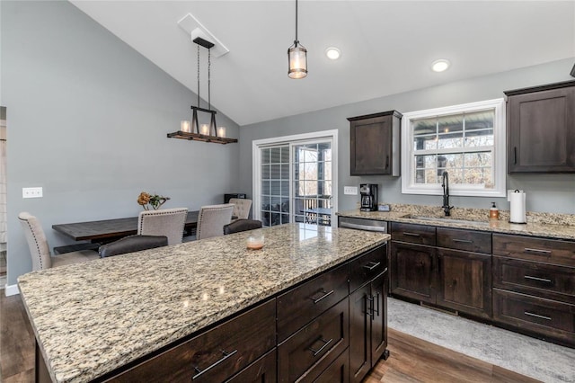 kitchen featuring a kitchen island, dark hardwood / wood-style flooring, sink, a healthy amount of sunlight, and lofted ceiling