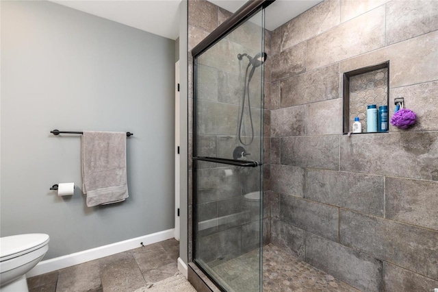 bathroom with an enclosed shower and toilet