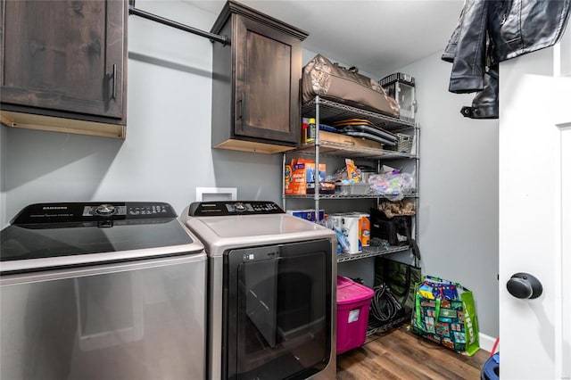 clothes washing area with cabinets, independent washer and dryer, and dark hardwood / wood-style floors