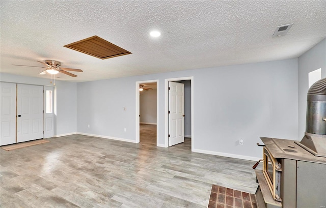 unfurnished living room featuring light hardwood / wood-style floors and a textured ceiling