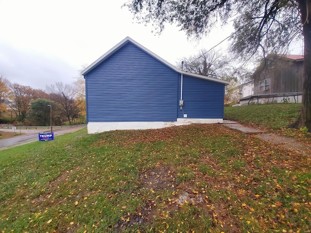 view of home's exterior with a lawn