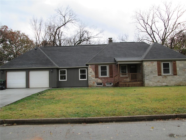 ranch-style house featuring a front yard and a garage