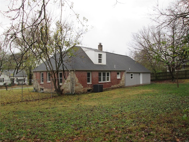 back of property featuring a lawn and cooling unit