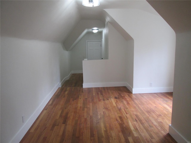 bonus room featuring dark hardwood / wood-style flooring and vaulted ceiling