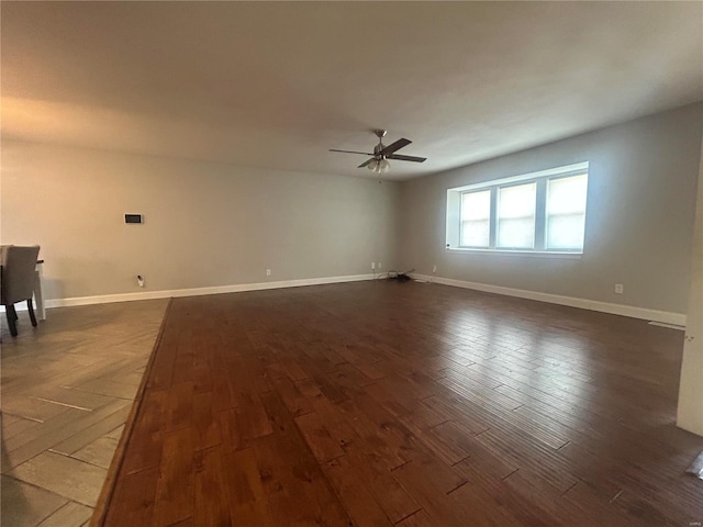 spare room with dark hardwood / wood-style floors and ceiling fan