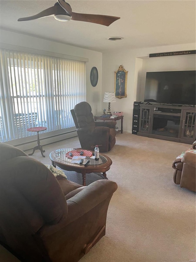 carpeted living room with ceiling fan