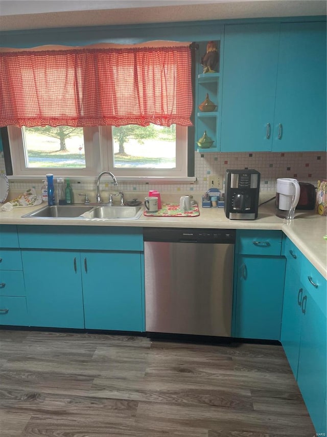 kitchen featuring sink, tasteful backsplash, blue cabinetry, stainless steel dishwasher, and dark hardwood / wood-style floors