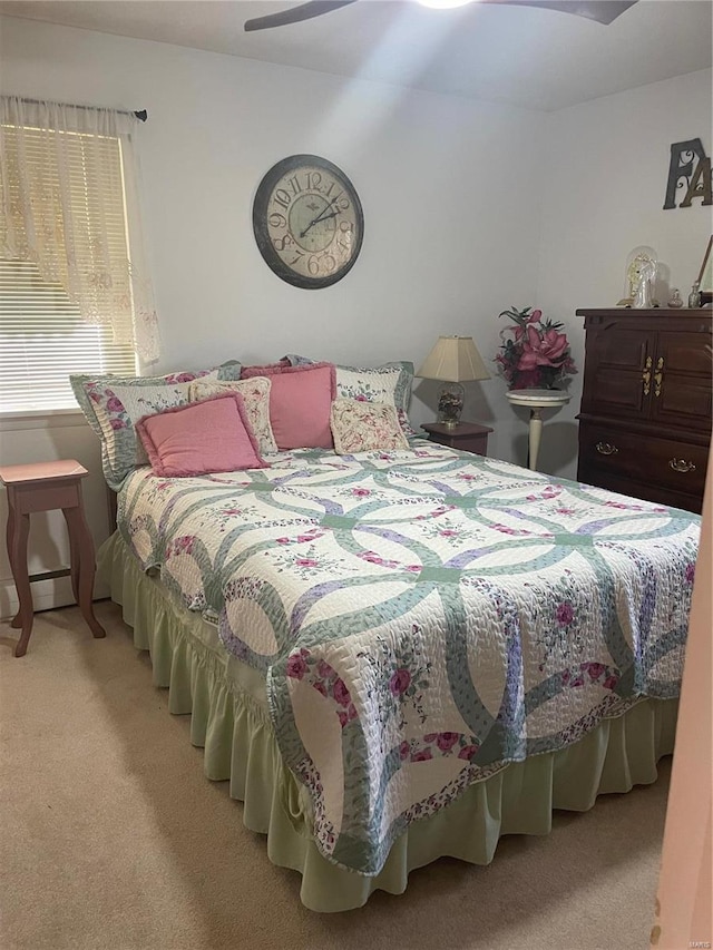 bedroom with light colored carpet and ceiling fan