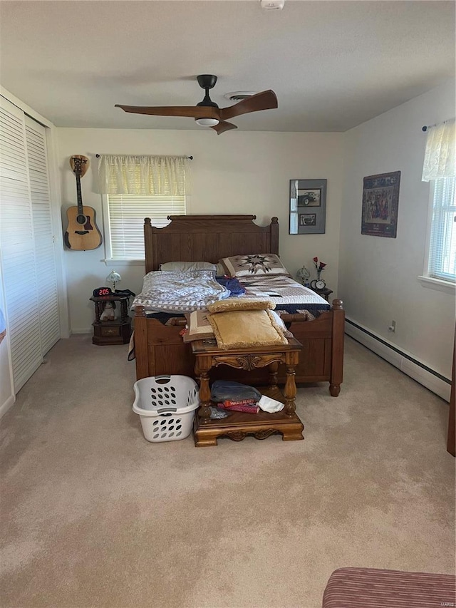 bedroom featuring baseboard heating, light colored carpet, and ceiling fan